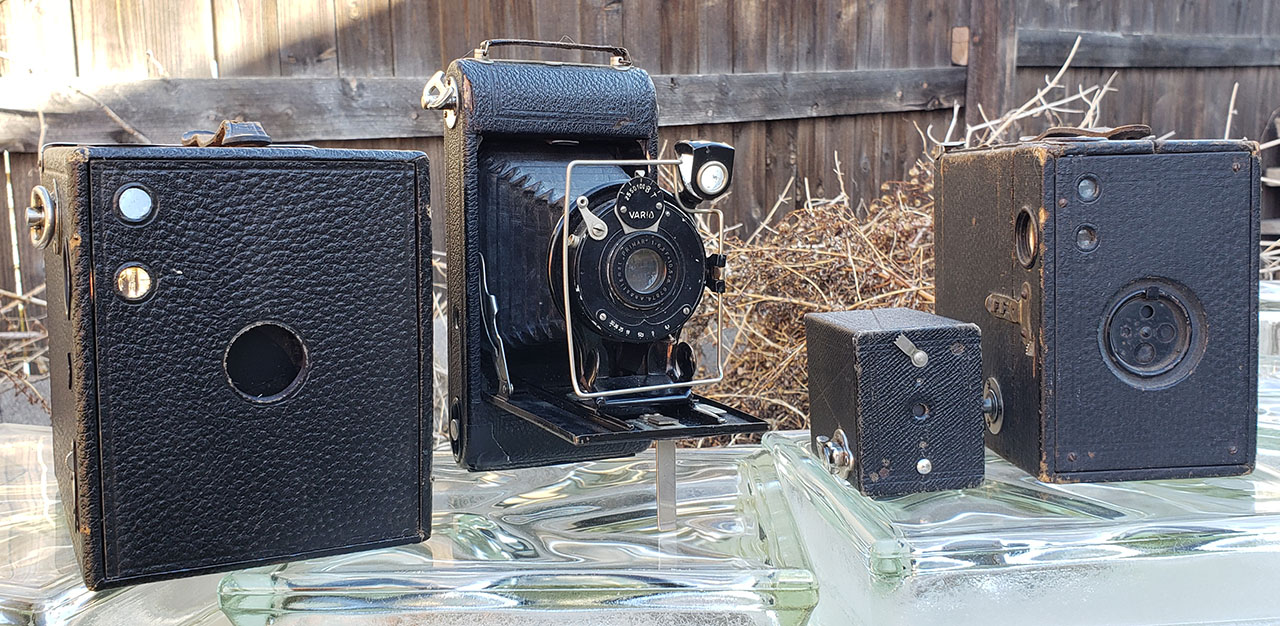 Conley Kewpie No. 2A, no-name Gauthier-based folding camera, Kodak No. 00 Cartridge Premo, Ansco Buster Brown No. 3 Box