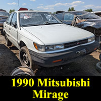 1990 Mitsubishi Mirage sedan in junkyard